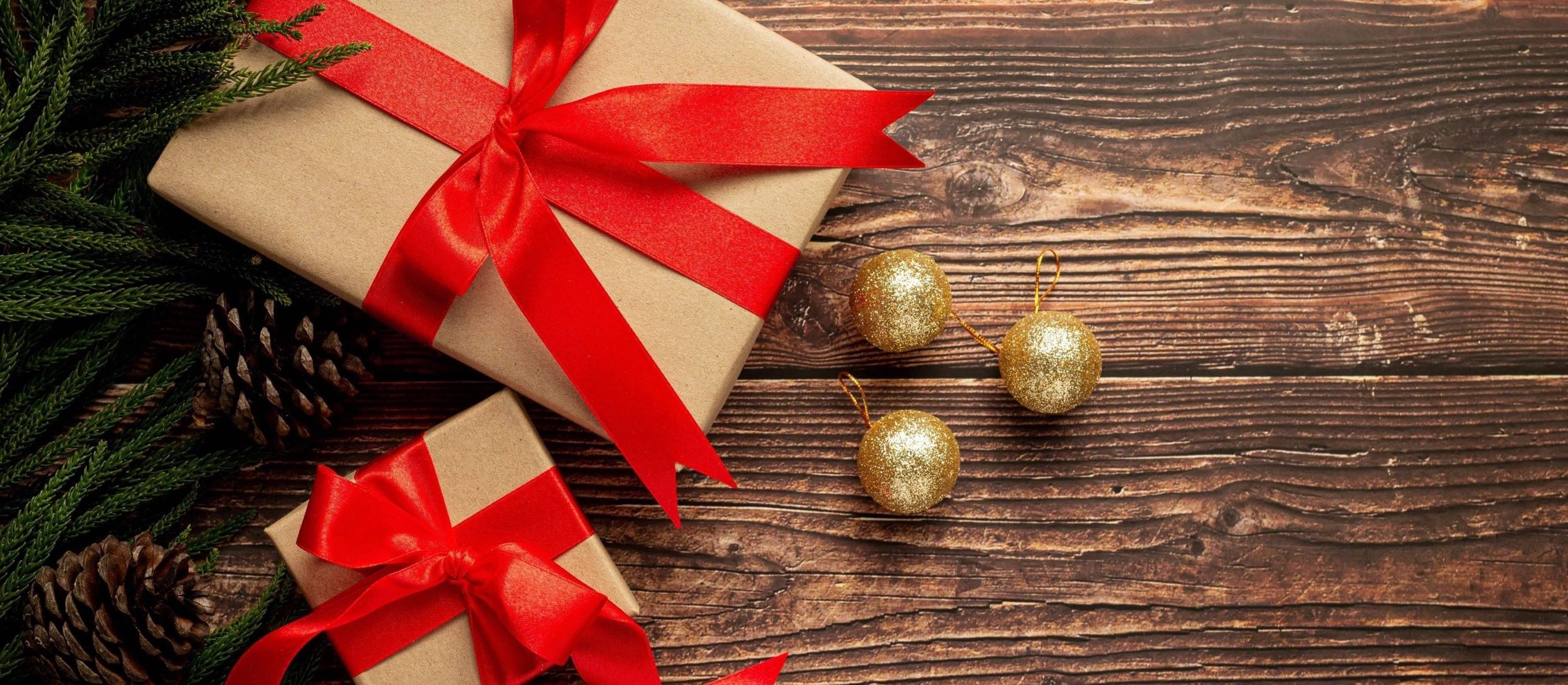 two boxes present with red ribbon bow wooden background 2